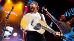 Chase Rice performing on stage at a country music concert